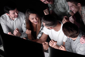 happy business team looking at computer monitor