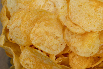 Tasty crisps on the kitchen table. Salty snacks as an addition to beer.