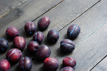 plums on black wooden table