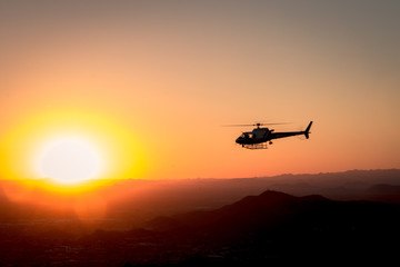 Fototapeta na wymiar helicopter silhouette in flight at sunset