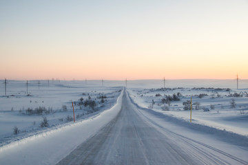 pink dawn in the tundra everywhere white snow nobody  road