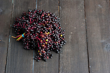 bunch of elderberry fruits on black wooden table