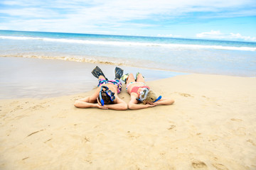 Fototapeta na wymiar Couple lay on the beach is going to swim and snorkle on hawaii beach