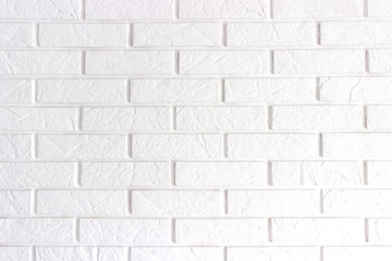 Wall is made from bricks and painted with white color.