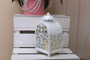 White wrought iron candle holder. Lantern made of forged metal