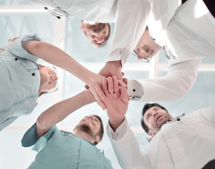 Obraz premium Health care workers demonstrating unity, bottom view