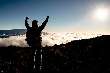 A Man on peak of mountain with arm high