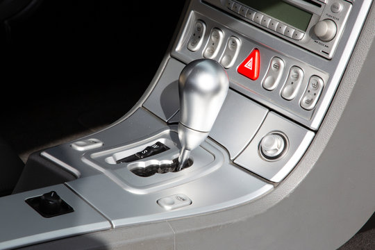 silver automatic gear stick of grey modern car interior details