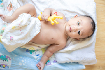 Smiling adorable infant 3 month baby lying on blanket