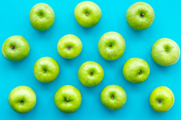 green apples for organic summer food pattern on blue background top view