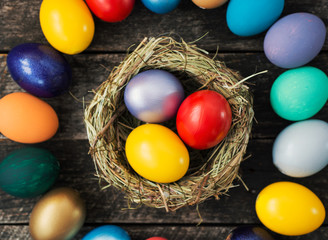 Easter colored eggs in egg nest, soft focus image. Happy Easter Card	