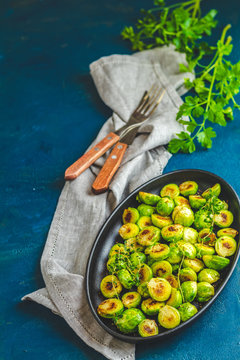 Black plate with delicious roasted Brussels sprouts