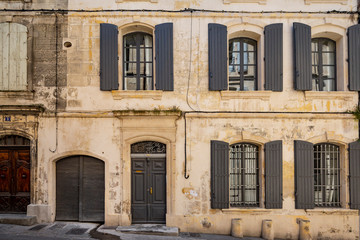 Beautiful typical French architecture in a narrow street in Arles, France