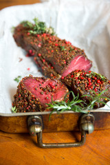Raw beef marinated in spices. Fresh beefsteak in marinade of pepper and herbs
