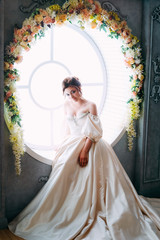 Tender charming princess in white satin dress