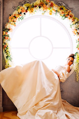 Tender charming princess in white satin dress