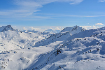 Summit mountain sunshine clouds traces in the snow