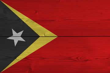 East Timor flag painted on old wood plank