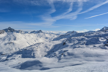 Fototapeta na wymiar Summit mountain sunshine clouds traces in the snow
