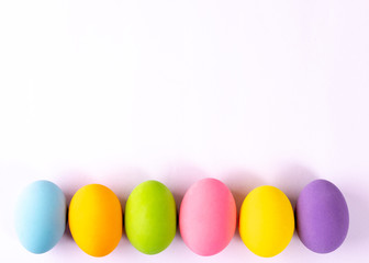 Fototapeta na wymiar Happy Easter. Easter eggs concept. Row Easter eggs on white paper background.