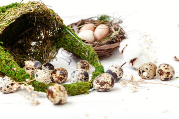 Easter decoration with eggs and basket on white wooden background. Easter egg hunt concept. Flat...