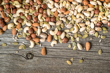 Mix of nut on a wooden background, top view