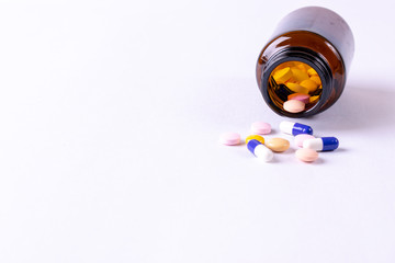 World health day, Healthcare and medical concept. The heap color mix tablets pills drug with white paper background. Pharmacy industry.