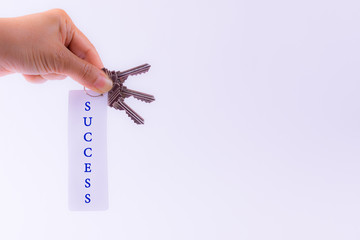 Motivation concept. Woman hand holding Key to success.