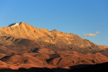 Abstract Landscape. Blue Open Sky, High Altitude Brown Mountains and Hills in the distance. Minimal Background, Open Space, Negative Space. Sichuan Province China. Tibetan Plateau Landscape