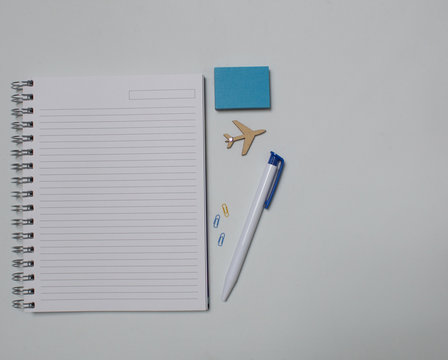 Notebook Blank Space, Pen, Paper Clips, Airplain In White Background