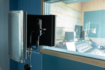 A microphone in the recording studio is ready for those who want to sing