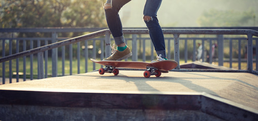 Skateboarder skateboarding at skatepark ramp