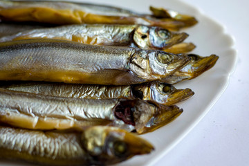 dried smoked capelin, tasty fish for beer on a platev