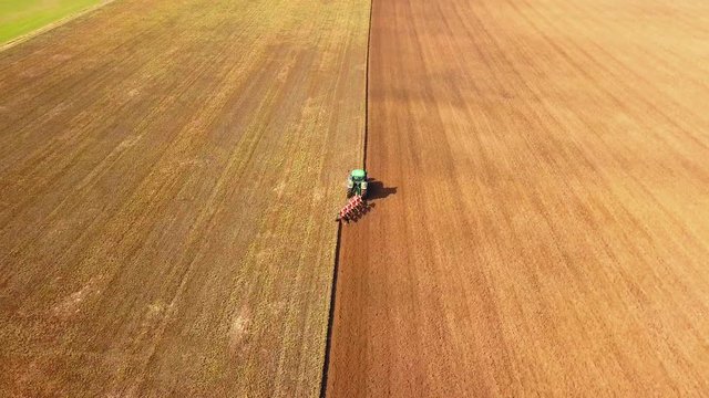 4k Aerial with Tractor plowing field. 3840x2160, 30fps