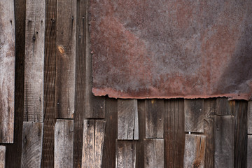 Old wooden wall with rusty iron fragment. For design, banner and layout.