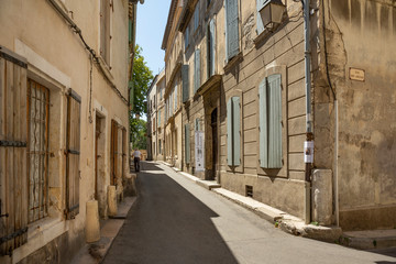 Blue shuttered windows on buildings in Arles, France.