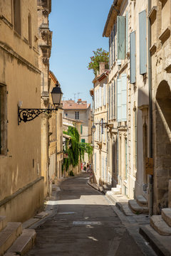 Fototapeta Beautiful typical French architecture in a narrow street in Arles, France