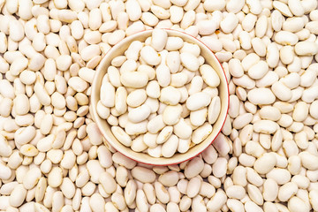 Dry lima beans stone background, in ceramic bowl, top view, wallpaper, close up, macro.