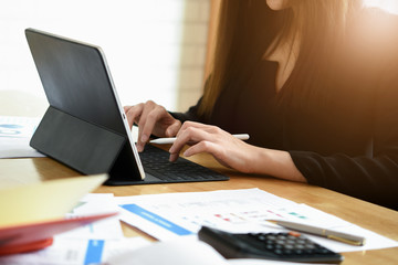 Businesswoman working with digital tablet computer for financial analysis