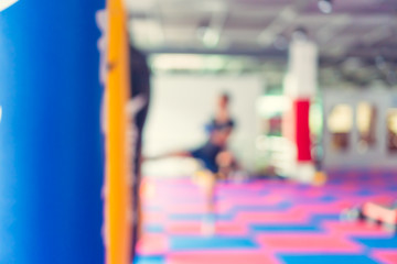 Blur man in fitness gym are boxing with boxing sack background.