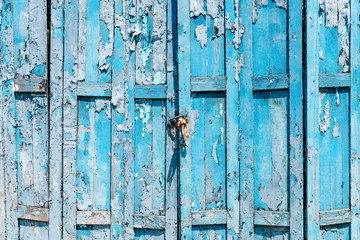 Detail of Old shabby blue wooden door background