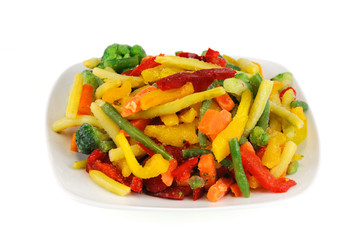 colorful frozen vegetable in the plate isolated on white background