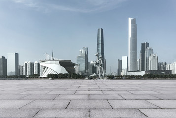 empty brick floor and cityscape of modern city near