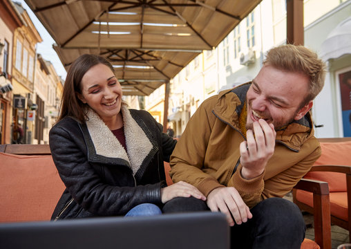 Two People, 20 - 29 Years Old, Candid Laughing Out Loud. Sitting In A Cafe.