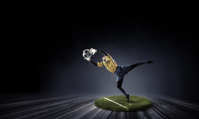 Soccer player on round pedestal. Mixed media