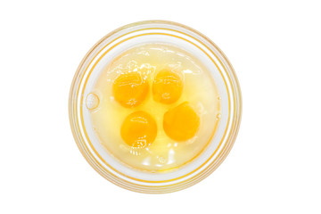 Four egg yolk and white in a bowl isolated on white. four pieces of raw egg in glass jar on white background