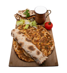 Turkish pizza, lahmacun, isolated on white background. lahmacun on a wooden table. Horizontal. one rolled with fresh garnish on the white surface.Cold buttermilk (ayran) near it.Close up taken,isolate