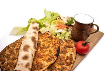 Turkish pizza, lahmacun, isolated on white background. lahmacun on a wooden table. Horizontal. one rolled with fresh garnish on the white surface.Cold buttermilk (ayran) near it.Close up taken,isolate