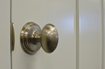 A soft oval nickel style handle on the new white door panel in the showroom. 