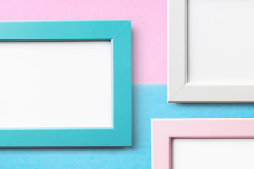 three white wood frame with blue and pink paper